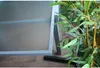 A close-up of a table with a plant next to it. Produktbild-Vorschau