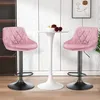 Two pink velvet bar stools are placed around a white tulip-style table, with a framed abstract artwork on the wall behind. Voir les images du produit