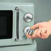 A hand is shown turning a dial on a retro-style microwave. Produktbild-Vorschau