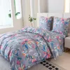 A bed with floral patterned bedding. Produktbild-Vorschau