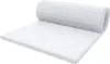 A white mattress topper rolled up on one end and lying flat on the other. Produktbild-Vorschau