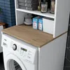 A close-up view of a washing machine with a wooden countertop and shelves above it, containing laundry supplies and towels. Voir les images du produit