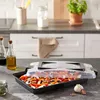 A kitchen counter with a baking dish filled with vegetables and a transparent lid. Náhľad obrázku produktu