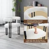A collage of images showing a white fluffy chair with black metal legs. One inset image shows a close-up of the chair's back padding, and another inset shows a hand pressing into the seat cushion. Produktbild-Vorschau