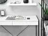 A close-up view of a modern white desk with black metal legs, featuring an open book, a smartphone, and a framed picture. Voir les images du produit