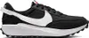 A side view of a black Nike Waffle Debut shoe with a white swoosh. Náhled obrázku produktu