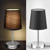 Two identical lamps, one lit and one unlit, are shown side-by-side against different backgrounds. Voir les images du produit