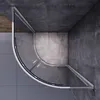 A top-down view of a modern shower enclosure in a bathroom with concrete walls and floor. Voir les images du produit