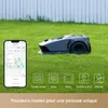 A robotic lawn mower is shown on a green lawn next to a smartphone displaying a map and various mowing modes. Produktbild-Vorschau