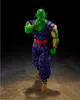 A full-body shot of a Piccolo action figure against a dark background with a sandy ground. Podgląd zdjęcia produktu