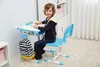 A young boy is sitting at a height-adjustable desk and chair, drawing. Produktbild-Vorschau