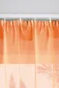 Close-up of orange sheer curtains hanging from a white curtain rod. Produktbild-Vorschau