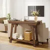 A living room scene featuring a wooden console table with decorative items and a sofa in the background. Podgląd zdjęcia produktu