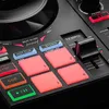 A close-up view of a DJ controller with illuminated buttons and a fader. Produktbild-Vorschau