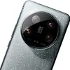 A close-up shot of the rear camera module of a smartphone, featuring the Leica branding and multiple lenses. The phone's back has a textured, water-droplet-like pattern. Produktbild-Vorschau