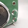 A close-up view of the side of a green vintage-style heater, showing two control knobs and a red indicator light. Náhled obrázku produktu