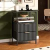 A nightstand with a turntable and drawers, placed in a room with green walls and wooden flooring. Náhled obrázku produktu