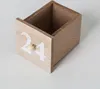 A close-up, slightly angled view of a wooden advent calendar drawer with the number 24 painted on it and a small wooden knob. Anteprima dell’immagine prodotto