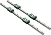 Two linear motion guide rails with bearing blocks on a white background. Podgląd zdjęcia produktu
