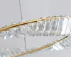 A close-up view of a gold-colored chandelier with clear crystal accents. Produktbild-Vorschau