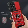 A hand holding a red and black phone case with a ring holder and camera cover. Produktbild-Vorschau