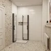 A modern bathroom with a shower cabin, terrazzo flooring, and tiled walls. Produktbild-Vorschau