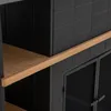 A close-up view of a black cabinet with wooden shelves and a metal mesh door. Náhled obrázku produktu