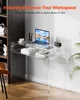 A clear acrylic desk with a laptop, books, and a coffee cup on it, set against a light gray wall. Anteprima dell’immagine prodotto