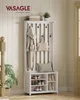 A white coat rack with a shoe bench is shown in a hallway with a plant and a staircase railing. Produktbild-Vorschau