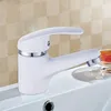 A white faucet with silver accents sits on the edge of a white sink. Produktbild-Vorschau