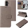 Multiple views of a gray flip phone case with floral and butterfly embossing. Produktbild-Vorschau