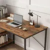 A desk with a laptop, lamp, and books. Podgląd zdjęcia produktu