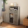 A grey wood-grain cabinet with two doors and two drawers, shown in a room setting with a window and a side table. Produktbild-Vorschau