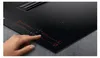 A hand is shown interacting with the control panel of a black induction cooktop. Anteprima dell’immagine prodotto