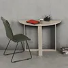 A green chair sits next to a light wood desk with a laptop and mug on it. Náhľad obrázku produktu