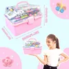 A collage showing a pink craft box filled with colorful craft supplies, a young girl holding a smaller version of the box, and decorative elements like a butterfly and a flower. Produktbild-Vorschau