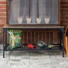 A mini greenhouse on a shelf with gardening tools and a bag of soil. Voir les images du produit
