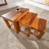 Three nested wooden tables of varying sizes on a carpet. Produktbild-Vorschau