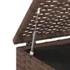 Close-up of a gas strut mechanism on a brown rattan storage box lid. Produktbild-Vorschau