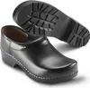 A pair of black Sika clogs shown from a slightly elevated side angle, with one clog in the foreground and the sole of another visible in the background. Anteprima dell’immagine prodotto