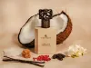 A perfume bottle is displayed with ingredients like coconut, vanilla beans, and spices. Anteprima dell’immagine prodotto