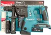 A Makita cordless combination hammer drill and its accessories are displayed against a white background, with the product packaging visible behind. Produktbild-Vorschau