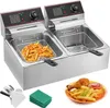 A commercial dual-basket deep fryer with a plate of fried food in the foreground. Produktbild-Vorschau