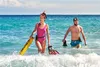 A man and a woman are walking in the ocean with snorkeling gear. Podgląd zdjęcia produktu