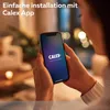 A person is holding a smartphone displaying the Calex Smart Home app, with text overlay indicating easy installation. Produktbild-Vorschau