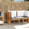 A wooden sofa with cushions is placed in front of a bamboo fence, with a small bookshelf to the left. Voir les images du produit