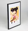 A framed picture of a woman holding macarons. Produktbild-Vorschau