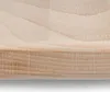 A close-up view of the edge of a wooden cutting board, showing the grain and texture of the wood. Voir les images du produit