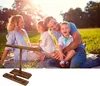 A family is having a picnic in a park and playing a ring toss game. Náhled obrázku produktu