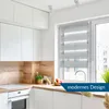 A modern kitchen with white cabinets, a wooden backsplash, and a window with blinds. Produktbild-Vorschau